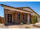 Attractive home with a brick facade, covered porch, and well-manicured desert landscaping at 19338 S 212Th Pl, Queen Creek, AZ 85142
