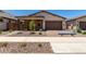Single-story home featuring a brick facade, desert landscaping, and a spacious two-car garage at 19338 S 212Th Pl, Queen Creek, AZ 85142
