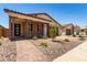 Inviting home with a covered porch, brick accents, and low-maintenance desert landscaping at 19338 S 212Th Pl, Queen Creek, AZ 85142
