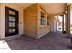 Covered front porch with brick accents and a stylish multi-pane front door at 19338 S 212Th Pl, Queen Creek, AZ 85142