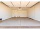 Spacious two car garage featuring a clean concrete floor, bright lighting and two entry doors at 19338 S 212Th Pl, Queen Creek, AZ 85142