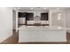 Bright kitchen features a large island with a sink and stainless steel appliances at 19338 S 212Th Pl, Queen Creek, AZ 85142