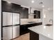 Kitchen features a stainless steel refrigerator and a center island with stone countertop at 19338 S 212Th Pl, Queen Creek, AZ 85142