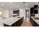 Spacious kitchen features an island, black cabinets, and stainless steel appliances at 19338 S 212Th Pl, Queen Creek, AZ 85142