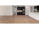 Open floor plan view of a kitchen and living area with light hardwood flooring at 19338 S 212Th Pl, Queen Creek, AZ 85142