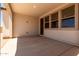 An open air patio with a concrete floor and finished ceiling featuring lighting and windows to the interior space at 19338 S 212Th Pl, Queen Creek, AZ 85142