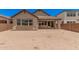 Wide open backyard featuring a single-story home with a covered patio and block fence at 19354 S 212Th Pl, Queen Creek, AZ 85142
