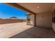 Covered patio in backyard with dirt landscaping under clear blue sky at 19354 S 212Th Pl, Queen Creek, AZ 85142