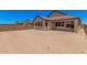 Large backyard featuring a single-story house with several windows and block fence at 19354 S 212Th Pl, Queen Creek, AZ 85142