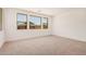 Bright bedroom with neutral carpet, showcasing great natural light with multiple windows at 19354 S 212Th Pl, Queen Creek, AZ 85142