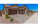 Stylish single-story home with a two-car garage and low-maintenance desert landscaping at 19354 S 212Th Pl, Queen Creek, AZ 85142