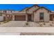 Charming single-story home featuring a two-car garage and well-manicured landscaping at 19354 S 212Th Pl, Queen Creek, AZ 85142