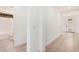 Bright hallway with tile flooring leads to a modern bathroom and the front door at 19354 S 212Th Pl, Queen Creek, AZ 85142