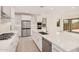 Bright kitchen with an island, stainless steel appliances, and sliding glass doors at 19354 S 212Th Pl, Queen Creek, AZ 85142
