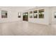 Bright living room featuring tile flooring, recessed lighting, and large windows at 19354 S 212Th Pl, Queen Creek, AZ 85142