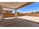 Large covered patio overlooking a spacious dirt backyard enclosed by a brick wall at 19434 S 212Th Pl, Queen Creek, AZ 85142