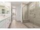Modern bathroom with white vanity, large glass shower, and bright natural light at 19434 S 212Th Pl, Queen Creek, AZ 85142