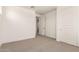 Cozy bedroom showcasing neutral carpet and a closet for storage solutions at 19434 S 212Th Pl, Queen Creek, AZ 85142