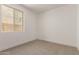 Neutral bedroom with a window and carpeted floor, perfect for creating a calming and comfortable space at 19434 S 212Th Pl, Queen Creek, AZ 85142