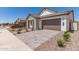 Attractive home featuring a two-car garage and low-maintenance desert landscaping at 19434 S 212Th Pl, Queen Creek, AZ 85142