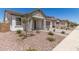 Inviting single-story home with stone accents, a two-car garage, and desert landscaping at 19434 S 212Th Pl, Queen Creek, AZ 85142