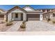 Charming single-story home featuring stone accents, a two-car garage, and beautiful desert landscaping at 19434 S 212Th Pl, Queen Creek, AZ 85142