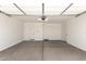 A spacious, unfinished two-car garage with sealed concrete floors and white walls at 19434 S 212Th Pl, Queen Creek, AZ 85142
