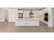 Modern kitchen with white cabinets, stainless steel appliances, large island, and views to connected living space at 19434 S 212Th Pl, Queen Creek, AZ 85142