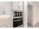 A close-up view of a built-in oven and microwave combo unit with modern cabinetry in an updated kitchen at 19434 S 212Th Pl, Queen Creek, AZ 85142