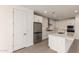 Bright kitchen with stainless steel refrigerator, white cabinetry and a spacious center island at 19434 S 212Th Pl, Queen Creek, AZ 85142