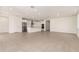 Spacious living room area with an open-concept layout connecting to a bright kitchen with white cabinetry at 19434 S 212Th Pl, Queen Creek, AZ 85142