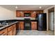 Kitchen with black appliances, oak cabinets and tile floors at 19601 N 7Th St # 1003, Phoenix, AZ 85024