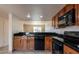 Classic kitchen featuring black appliances and tile countertops at 19601 N 7Th St # 1003, Phoenix, AZ 85024