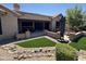 Inviting backyard patio with multiple seating areas and low-maintenance landscaping at 19882 N Crimson Ridge Way, Surprise, AZ 85374