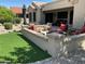 Outdoor living space with seating areas and a view of the well-maintained yard at 19882 N Crimson Ridge Way, Surprise, AZ 85374