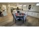 Open-concept kitchen and dining area boasts white cabinets and new hardwood style flooring and lots of light at 19882 N Crimson Ridge Way, Surprise, AZ 85374