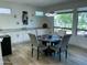 Inviting dining area with hardwood floors, modern lighting, and an open layout connected to the kitchen at 19882 N Crimson Ridge Way, Surprise, AZ 85374