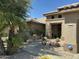 Inviting front entrance with desert landscaping and a covered entryway with a security system sign at 19882 N Crimson Ridge Way, Surprise, AZ 85374