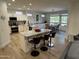 Open-concept kitchen boasts granite countertops, a kitchen island with seating and an adjacent dining space at 19882 N Crimson Ridge Way, Surprise, AZ 85374