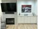 Bright living room featuring a fireplace and custom built-in cabinets at 19882 N Crimson Ridge Way, Surprise, AZ 85374