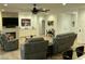 Comfortable living room with a ceiling fan, fireplace, and plenty of seating at 19882 N Crimson Ridge Way, Surprise, AZ 85374