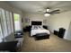 Spacious main bedroom featuring plantation shutters and ceiling fan at 19882 N Crimson Ridge Way, Surprise, AZ 85374