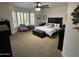 Bright main bedroom with plantation shutters and a cozy seating area at 19882 N Crimson Ridge Way, Surprise, AZ 85374
