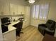 Functional office with custom cabinets, desk, and cozy reading chair at 19882 N Crimson Ridge Way, Surprise, AZ 85374