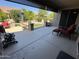 Spacious covered patio with stylish furniture and a serene view of the well-maintained backyard at 19882 N Crimson Ridge Way, Surprise, AZ 85374