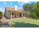 Charming backyard with artificial turf, mature trees, covered patio, and easy to care for desert landscaping at 20352 N 109Th Dr, Peoria, AZ 85373