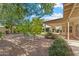 Beautiful backyard featuring mature trees, a covered patio, and low maintenance landscaping, perfect for relaxing outdoors at 20352 N 109Th Dr, Peoria, AZ 85373