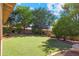 Serene backyard oasis with lush artificial turf, perfect for outdoor activities and relaxation, surrounded by mature landscaping at 20352 N 109Th Dr, Peoria, AZ 85373