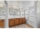 Bathroom features dual sinks, wood cabinets, tub and shower combination at 20352 N 109Th Dr, Peoria, AZ 85373