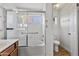 White bathroom features a tub with shower, tile surround, and grab bars at 20352 N 109Th Dr, Peoria, AZ 85373